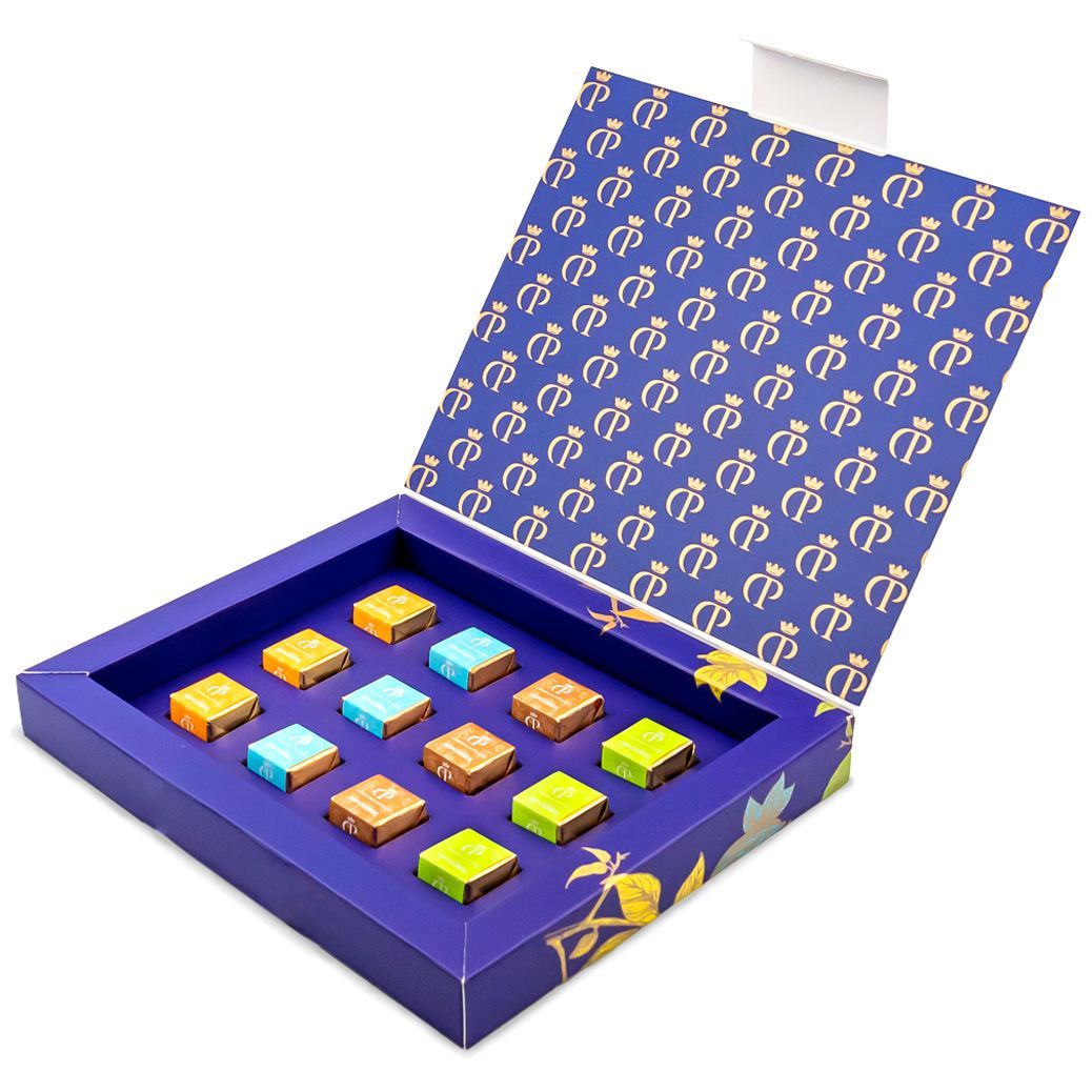Descubre nuestros Topolinos: surtido de bombones artesanales con pralinés de pistacho, almendra-avellana, café y naranja. Elegancia y sabor único en cada bocado - Caja abierta